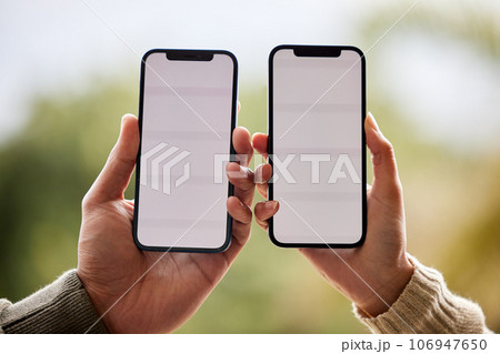 Its a match made in heaven. an unrecognisable couple holding their cellphones next to each other. 106947650