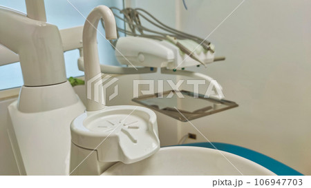 Modern dental office. Dental chair and other accessories used by dentists in blue, medical light 106947703