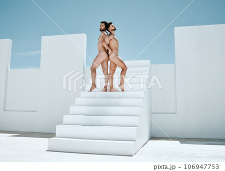 Art, naked men posing in sun together, architecture and blue sky, muscle and athletic lgbt body. Pride, power and gay couple in artistic Greek athlete statue pose, freedom in creative self expression Art, naked men posing in sun together, architecture and blue sky, muscle and athletic lgbt body. Pride, power and gay couple in artistic Greek athlete statue pose, freedom in creative self expression 106947753