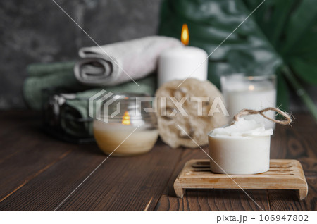 Natural soap, loofah scrubber on podium in bathroom. Zero waste in life. Relaxation spa concept, candles, beauty... Natural soap, loofah scrubber on podium in bathroom. Zero waste in life. Relaxation spa concept, candles, beauty... 106947802