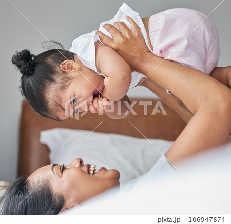 Love, mother and baby in bedroom, air and care with happiness, playful and cheerful. Mama, female child and kid on bed, smile and bonding together, break and loving with toddler, family and relax 106947874