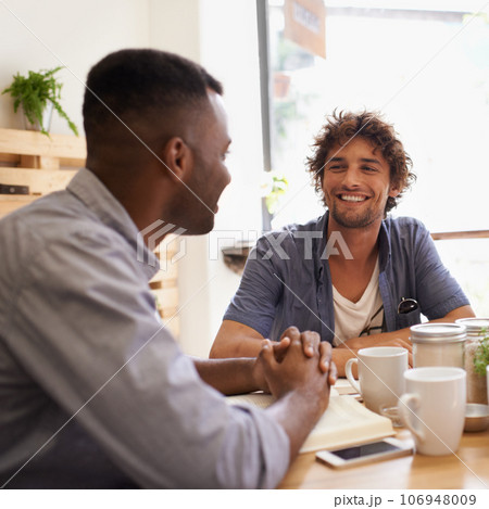 Dude, so how are you doing. Two young men having a conversation while having coffee at a cafe. 106948009