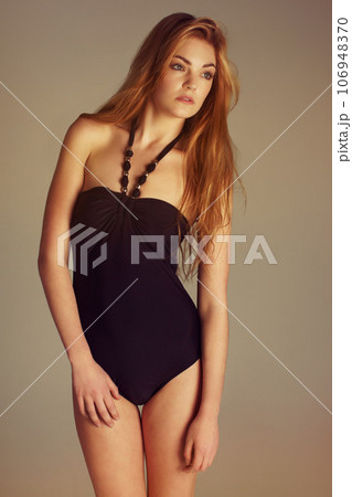 Swimsuit, fashion and young girl in studio with confident, beautiful and posing on wall background. Bodysuit, pose and fashionable gen z female model person with style or summer aesthetic Swimsuit, fashion and young girl in studio with confident, beautiful and posing on wall background. Bodysuit, pose and fashionable gen z female model person with style or summer aesthetic 106948370