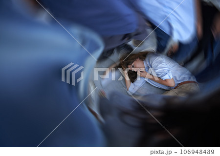 Its all too much. Shot of a young woman curled up on the floor in a panic state. 106948489