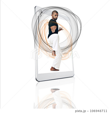 Tablet, portrait and fitness app with a karate man on a screen in studio isolated on a white background. Technology, workout for self defense and vaporwave with a male athlete in a digital display Tablet, portrait and fitness app with a karate man on a screen in studio isolated on a white background. Technology, workout for self defense and vaporwave with a male athlete in a digital display 106948711