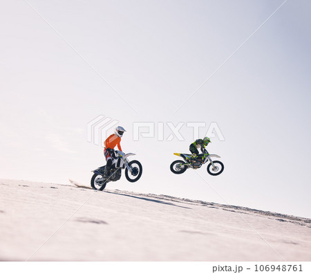 Sports, jump and people on motorcycle driving on sand, beach or training for a challenge, competition or desert rally mockup. Dirt, motorbike and fearless extreme stunt or jumping in space or air Sports, jump and people on motorcycle driving on sand, beach or training for a challenge, competition or desert rally mockup. Dirt, motorbike and fearless extreme stunt or jumping in space or air 106948761