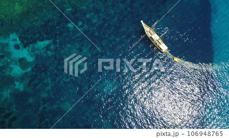 Aerial, boat and sailing in water, summer on ocean holiday and relax in freedom with nature from above. Yacht vacation, travel in Croatia and tropical cruise on sea adventure to island in sunshine. Aerial, boat and sailing in water, summer on ocean holiday and relax in freedom with nature from above. Yacht vacation, travel in Croatia and tropical cruise on sea adventure to island in sunshine. 106948765