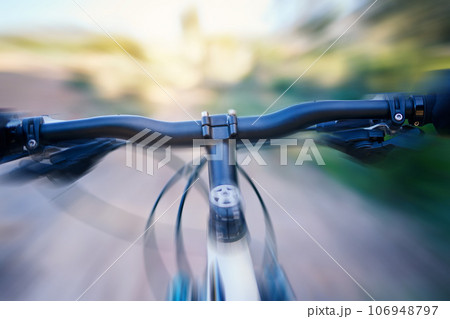 Fast, blur and a bicycle in nature for cycling, fitness or training for a marathon. Speed, road and a bike in motion for sports, triathlon or exrcise in the countryside while moving for cardio Fast, blur and a bicycle in nature for cycling, fitness or training for a marathon. Speed, road and a bike in motion for sports, triathlon or exrcise in the countryside while moving for cardio 106948797