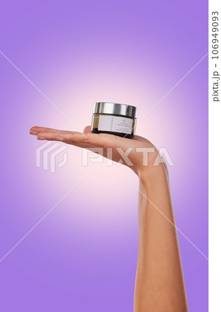 Hand, cream or serum with beauty and skincare, advertising product with dermatology isolated on purple background. Person with cosmetics for skin and promotion, container and facial mask in studio 106949093