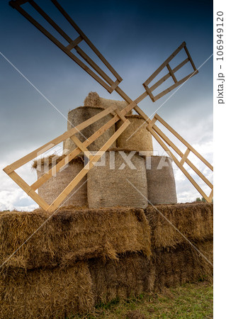 decorative mill from straw bales in the field 106949120