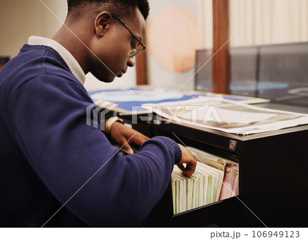 School research, campus and a black man in a library for knowledge, learning or studying. University, scholarship and a young African person or student looking at books for decision or choice 106949123