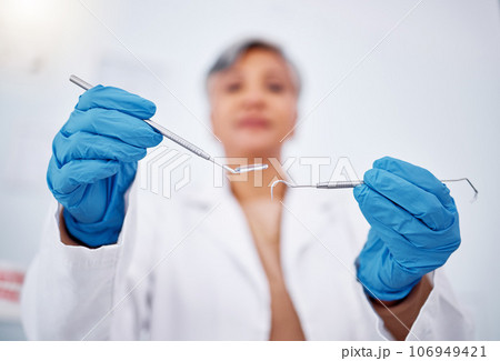 Dentist, hands and tools, healthcare and person at clinic for teeth cleaning, wellness and excavator for cavity. Dentist, metal equipment and health closeup, orthodontics and dental care with gloves Dentist, hands and tools, healthcare and person at clinic for teeth cleaning, wellness and excavator for cavity. Dentist, metal equipment and health closeup, orthodontics and dental care with gloves 106949421