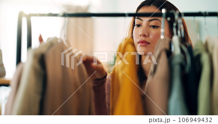 Retail clothes, happy shopping and woman in luxury designer store for fashion choice on railing in boutique. Rich Asian customer with wealth looking for clothing on discount during sale in mall 106949432