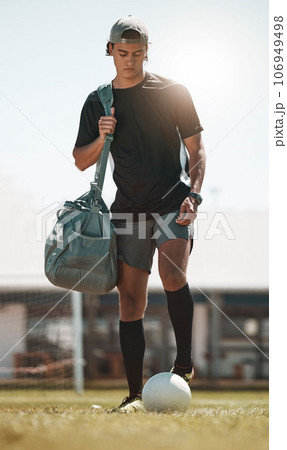 Football, training and exercise man with ball on sport field after training, practice and workout with bag. Athlete, soccer and fitness on sports ground after healthy sports cardio outdoor in summer 106949498