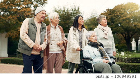 Retirement, walking and senior friends in park for bonding, wellness and quality time together outdoor. Wheelchair, nature and elderly man and women with caregiver for fresh air, health and relax 106949591