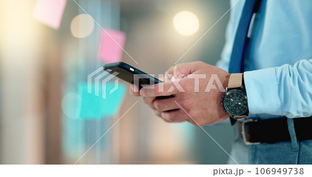 Businessman texting an email on his phone in a modern office. Corporate worker schedule a meeting with an instant business text message app. Closeup of trendy man sharing ideas online on social media 106949738