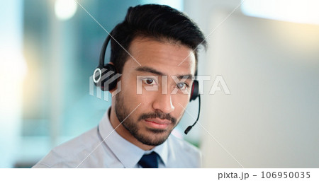 Call center agent talking and listening to a client on a headset while working in an office. Confident and reassuring salesman consulting and operating a helpdesk for customer service and support Call center agent talking and listening to a client on a headset while working in an office. Confident and reassuring salesman consulting and operating a helpdesk for customer service and support 106950035