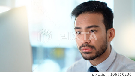 Business man reading his emails and browsing online on a desktop computer while working in an office at work. One male corporate worker while networking and connecting with clients on the internet Business man reading his emails and browsing online on a desktop computer while working in an office at work. One male corporate worker while networking and connecting with clients on the internet 106950230