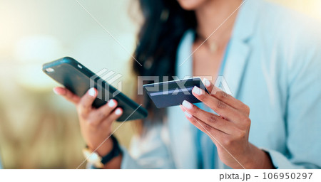 Bank card data put in phone by a lady who does internet banking by typing on her mobile to make an online credit payment. Young woman texting on her phone to send money via an ewallet transaction 106950297