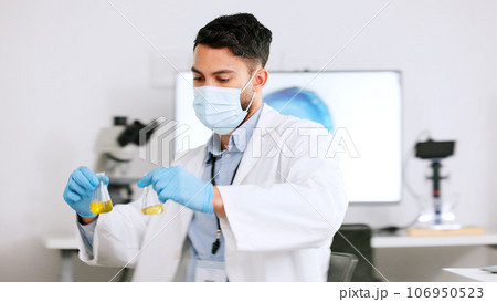 Scientist and research or medical engineer doing experiments to create a cure in a lab while wearing a mask. Healthcare professional working with science equipment and writing notes in a laboratory Scientist and research or medical engineer doing experiments to create a cure in a lab while wearing a mask. Healthcare professional working with science equipment and writing notes in a laboratory 106950523