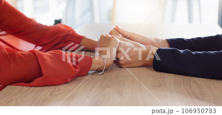 Love, empathy and friends holding hands in comfort, support or solidarity during grief, loss or mourning. Depression, mental health and anxiety with two people praying together in trust for help Love, empathy and friends holding hands in comfort, support or solidarity during grief, loss or mourning. Depression, mental health and anxiety with two people praying together in trust for help 106950783