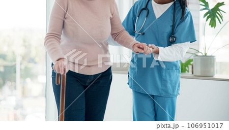 Caregiver hands, disabled and old woman with walking stick for support, senior wellness care or movement disability. Elderly rehabilitation service, retirement home and nurse help patient with cane 106951017