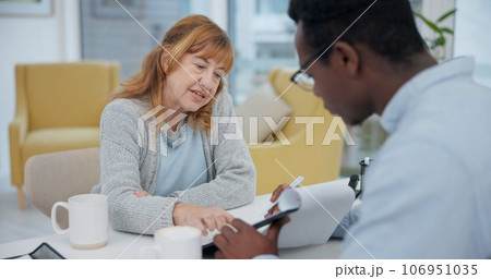 Talking, results and woman with black man or doctor for healthcare, insurance or checklist. Wellness, consulting and a senior patient speaking to an African clinic worker with a document for surgery 106951035
