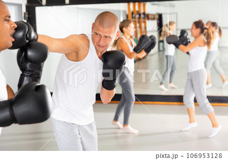 Two men practicing self defense techniques in sports club Two men practicing self defense techniques in sports club 106953128