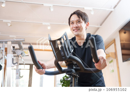 スポーツジムのエアロバイクで運動する男性(健康・ダイエット) スポーツジムのエアロバイクで運動する男性(健康・ダイエット) 106955102