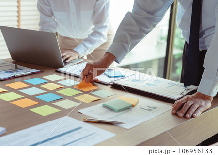 Business colleagues putting sticky notes on table to brainstorming and coworking about new business Business colleagues putting sticky notes on table to brainstorming and coworking about new business 106956133