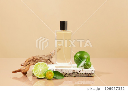 Spray bottle containing liquid placed on stone podium with kumquats and limes. The scent of Lime and Kumquat essential oil creates a feeling of comfort Spray bottle containing liquid placed on stone podium with kumquats and limes. The scent of Lime and Kumquat essential oil creates a feeling of comfort 106957352