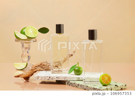 Transparent bottles decorated with fresh limes and kumquats on the stone podiums. Lime and Kumquat can help your body fight off infections 106957353