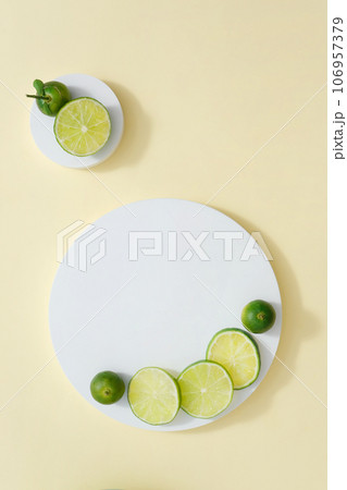 Two white podiums with round slices of lime and kumquat placed on. Minimalist mockup for podium display or showcase your product extracted from Lime and Kumquat 106957379