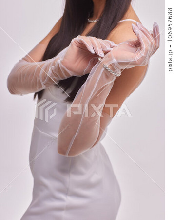 Female hands in transparent black gloves on dress background. Retro style.. Female hands in transparent black gloves on dress background. Retro style.. 106957688