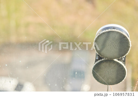 A window cleaner robot washes glass against the backdrop of multi-storey buildings. 106957831