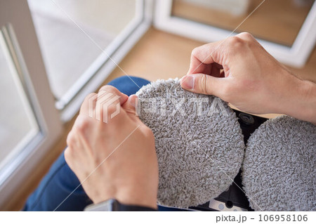 A window cleaner robot washes glass against the backdrop of multi-storey buildings. 106958106