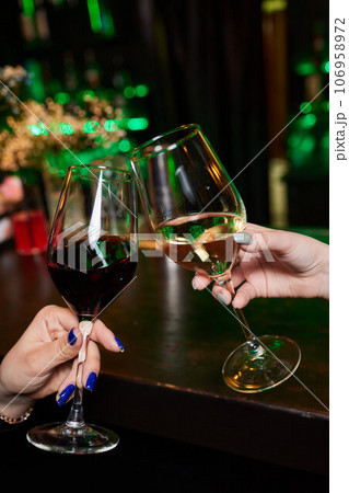 Clinking glasses with alcohol and toasting, party. 106958972