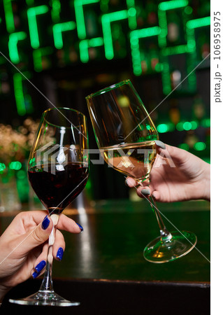 Clinking glasses with alcohol and toasting, party. 106958975