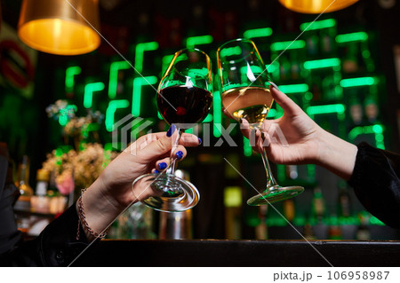 Clinking glasses with alcohol and toasting, party. 106958987
