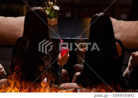 Clinking glasses with alcohol and toasting, party. 106958991