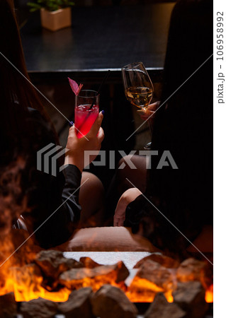 Clinking glasses with alcohol and toasting, party. 106958992