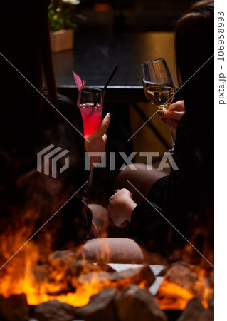 Clinking glasses with alcohol and toasting, party. 106958993