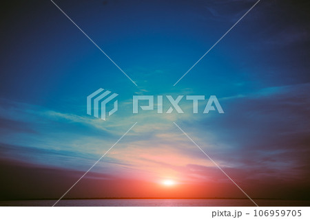 Colorful cloudy sky over the sea at sunset. Sky texture, abstract nature background Colorful cloudy sky over the sea at sunset. Sky texture, abstract nature background 106959705