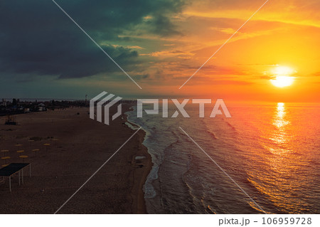 Seascape in the early morning. Sunrise over the sea. Calm sea with beautiful sky. Nature landscape. Sandy beach in summer Seascape in the early morning. Sunrise over the sea. Calm sea with beautiful sky. Nature landscape. Sandy beach in summer 106959728