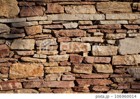 Sturdy yellow and beige cut stone wall made in Datca, Turkey, seamless lined up Sturdy yellow and beige cut stone wall made in Datca, Turkey, seamless lined up 106960014