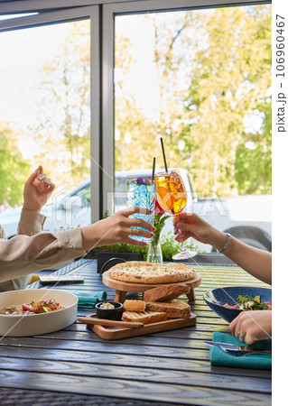 Clinking glasses with alcohol and toasting, party. 106960467