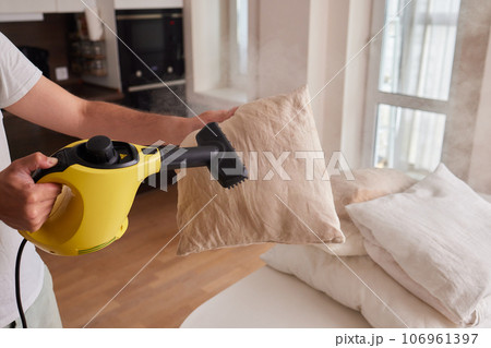 Premium Photo  Using dry steam cleaner to sanitize pillow