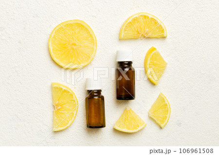Bottles with lemon fruit essential oil on wooden background. alternative medicine top view with copy space 106961508