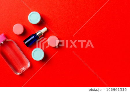 Cosmetics SPA branding mock-up, top view with copy space. set of tubes and jars of cream flat lay on colored background Cosmetics SPA branding mock-up, top view with copy space. set of tubes and jars of cream flat lay on colored background 106961536