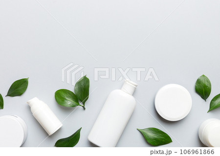 Organic cosmetic products with green leaves on color background. Copy space, flat lay Organic cosmetic products with green leaves on color background. Copy space, flat lay 106961866